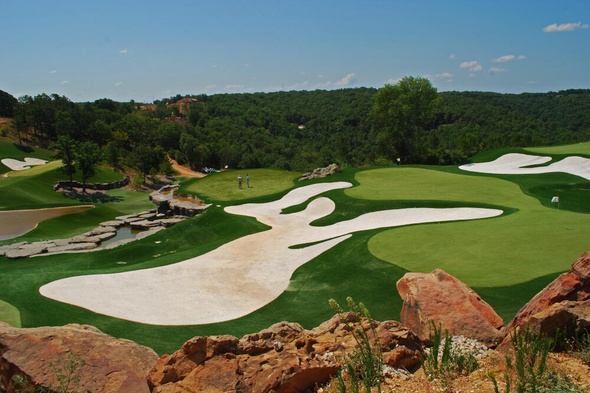 Huntsville lush green synthetic grass golf course with white sand bunkers and blue sky